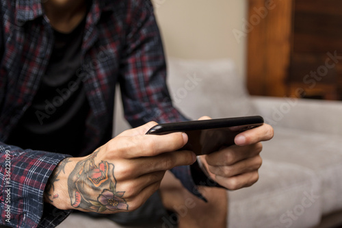 Young man paying a mobile game at home. Smart phone gaming © phaelshoots