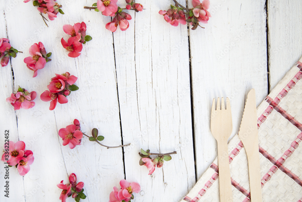 Frame with pink buds of flowers, branches and leaves isolated on a white background. layout, top view, copy space. Frame with pink buds of flowers, branches and leaves isolated on a white background. layout, top view, copy space.