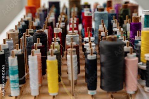 Collection of multicolored thread spools photo