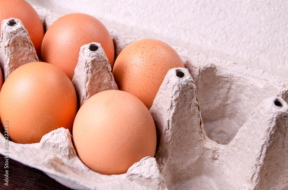 Cardboard egg box with six brown eggs Cardboard egg box with six brown eggs