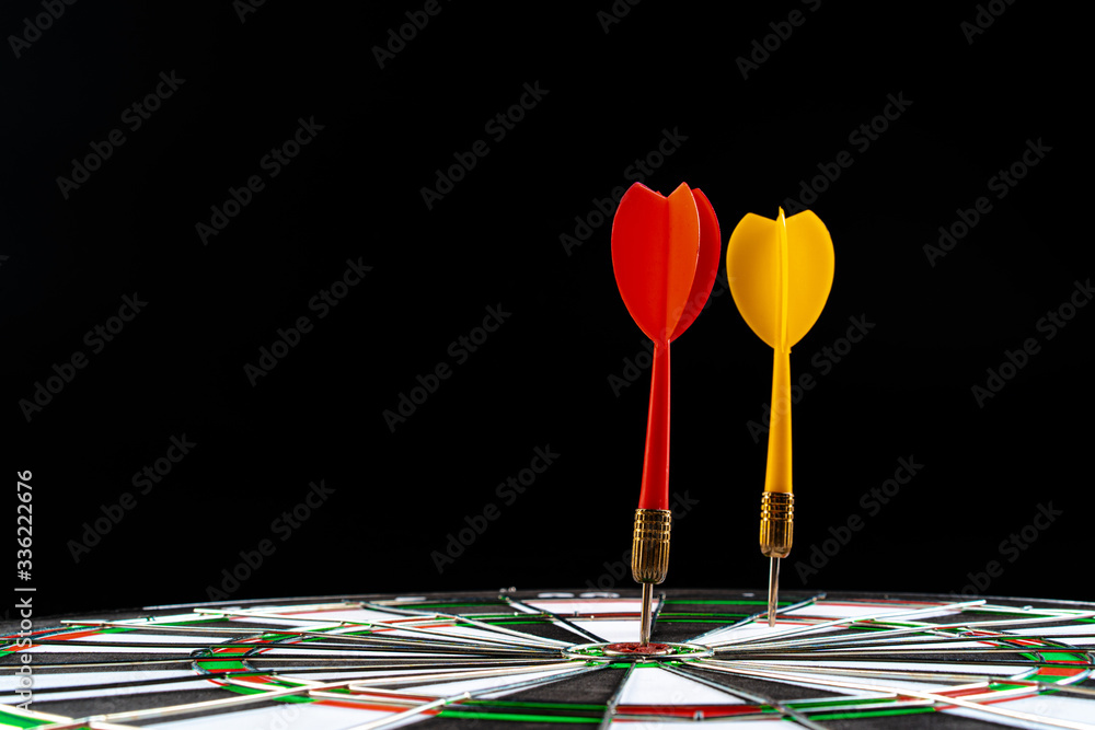 Dartboard on black dark background close up. Aiming concept Dartboard on black dark background close up. Aiming concept
