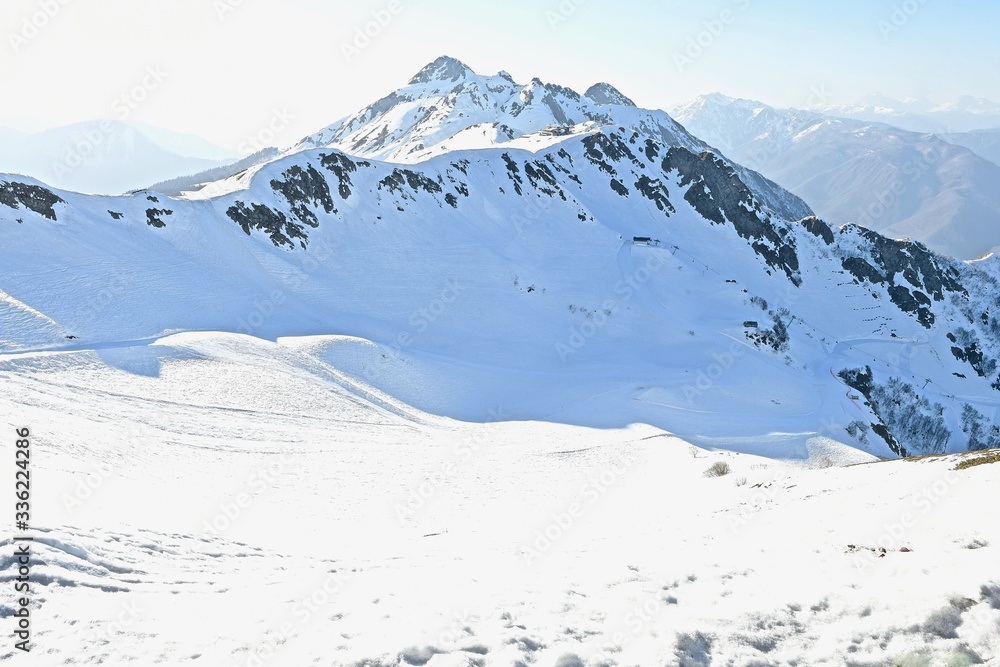 panorama of snow-capped peaks of mountains and clouds