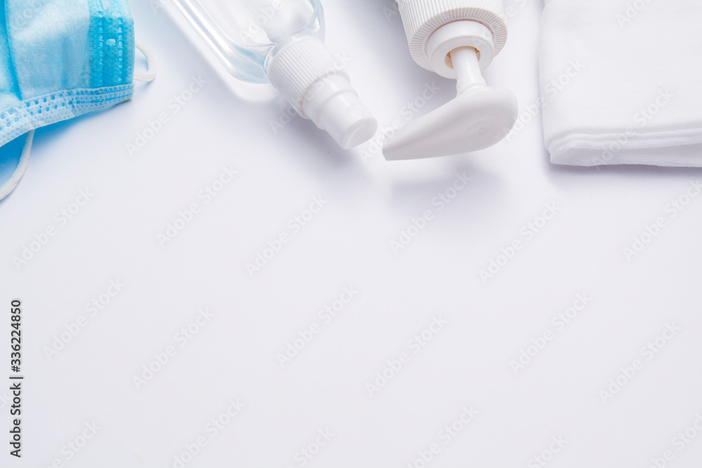 Coronavirus protection on a white background. Liquid soap, disinfector, medical mask, napkins - virus control concept