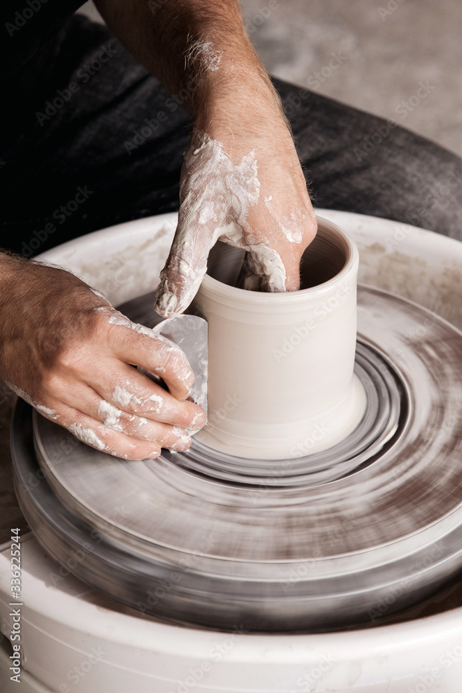 Potter throwing new shape on a wheel Potter throwing new shape on a wheel
