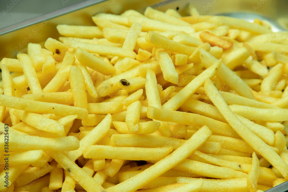 Delicious French fries piled up in a tray Delicious French fries piled up in a tray