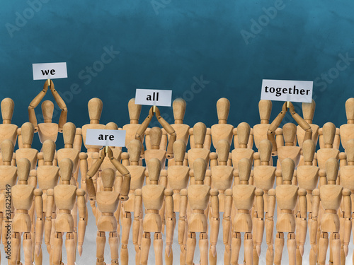 Wooden mannequin, we are all togather - stands on a white background