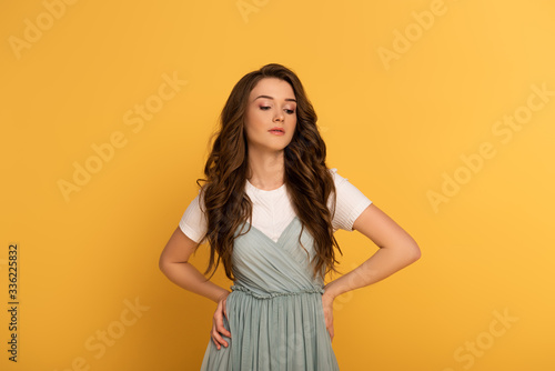 beautiful spring girl in t-shirt and dress on yellow