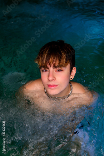 Teenager smiling in a swimming pool photo
