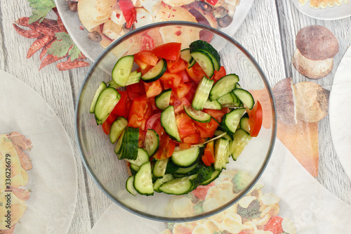 Sliced ​​cucumber and tomato vegetable salad in a glass bowl