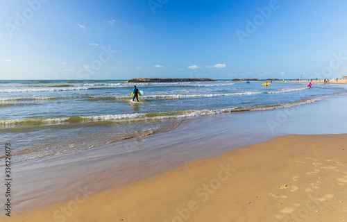 Surfers ride the waves on t...