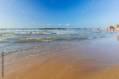Surfers ride the waves on t...