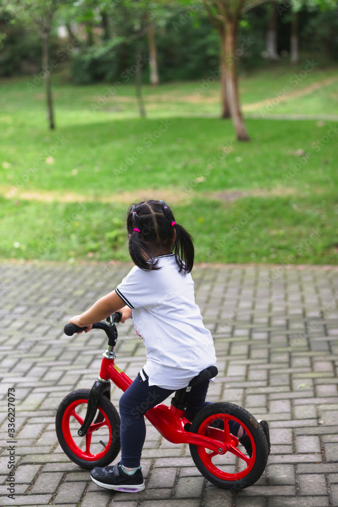 little girl riding bike in the park little girl riding bike in the park