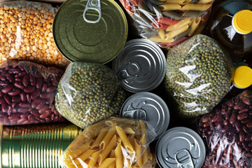 Donations food with canned food on the table background. Donate concept. Close up.
