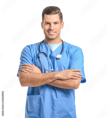 Portrait of young male doctor on white background