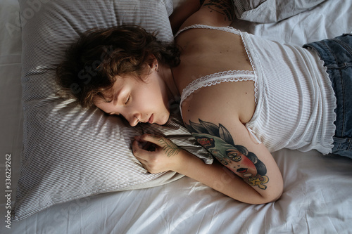 Curvy female sleeping on bed