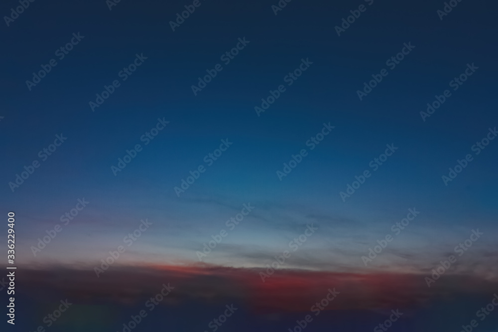 Fototapeta premium The sky at sunset. Cumulus clouds lit by the rays of the setting sun.