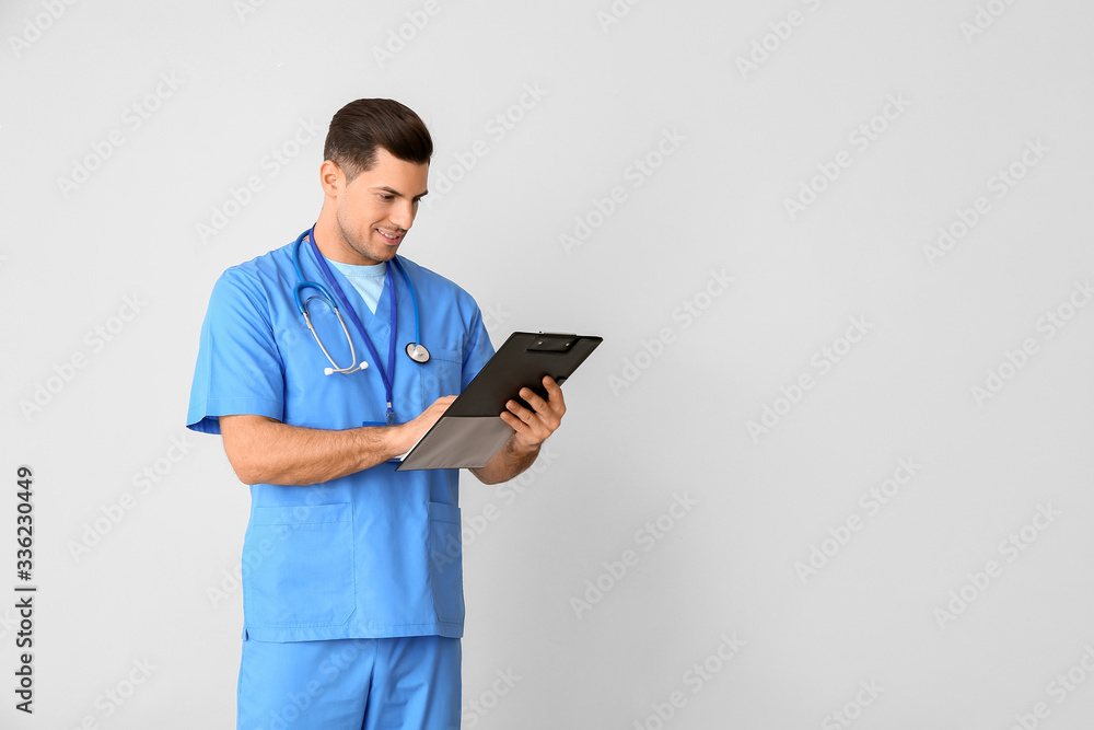 Portrait of young male doctor on light background Portrait of young male doctor on light background