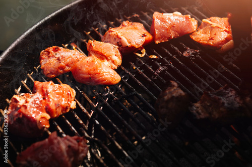 grilled meat in an open-air barbecue. Pork, sausages, beef on the coals.