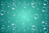 Soap bubbles sparkling on a turquoise background.