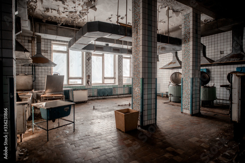 Old shabby kitchen in abandoned building photo