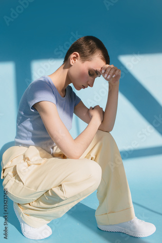 Bald model posing on isolated blue background photo