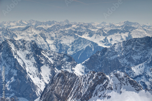 Endless mass of snowy ridges, peaks and rock faces of Mieminger Kette and Stubaier Alpen ranges in spring sunshine from Zugspitze, Northern Limestone Alps / Central Eastern Alps Tyrol Austria Europe