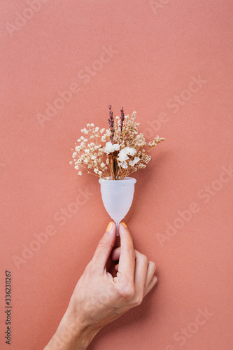 Hand holding a menstrual cup. photo