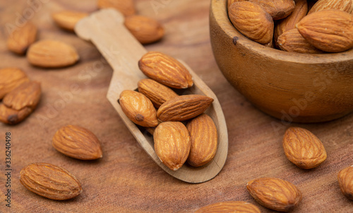 Closeup view of almond with wooden spoon