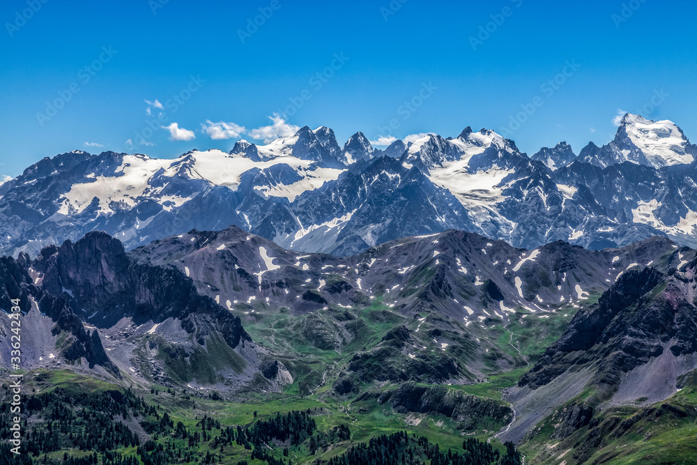 High altitude landscape in Alps with the view of Barre des Ecrins and La Meije in the distance. 