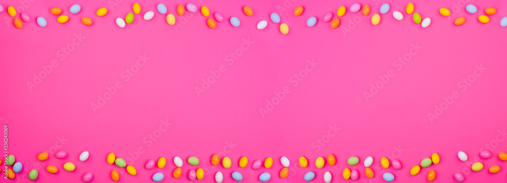 A lot of colored easter eggs, on a pink background. symbol of the spring holiday. Happy Easter card with copy space for text. Minimal style. Banner. Long format A lot of colored easter eggs, on a pink background. symbol of the spring holiday. Happy Easter card with copy space for text. Minimal style. Banner. Long format