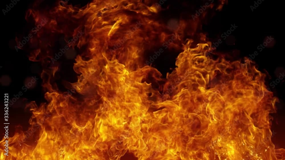 Flaming fire with black background and flying sparks Flaming fire with black background and flying sparks