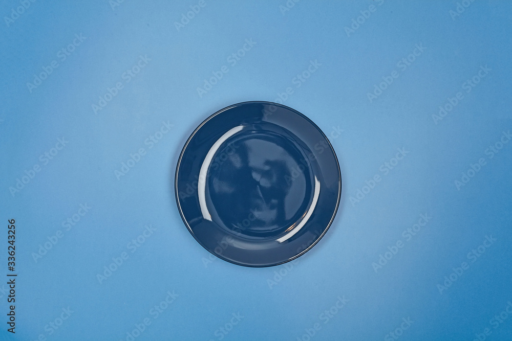 Blue dinner plate on color background. Close up. Blue dinner plate on color background. Close up.