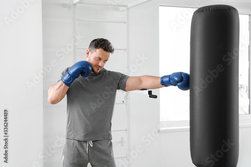 Male boxer training in gym