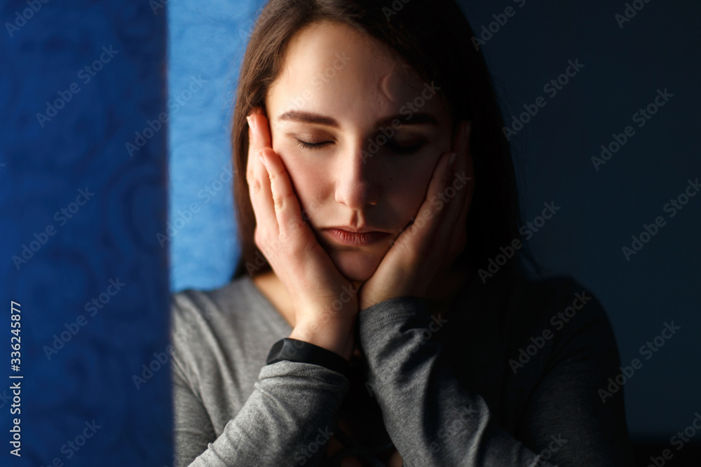Portrait of a beautiful girl with closed eyes in the blue room Portrait of a beautiful girl with closed eyes in the blue room