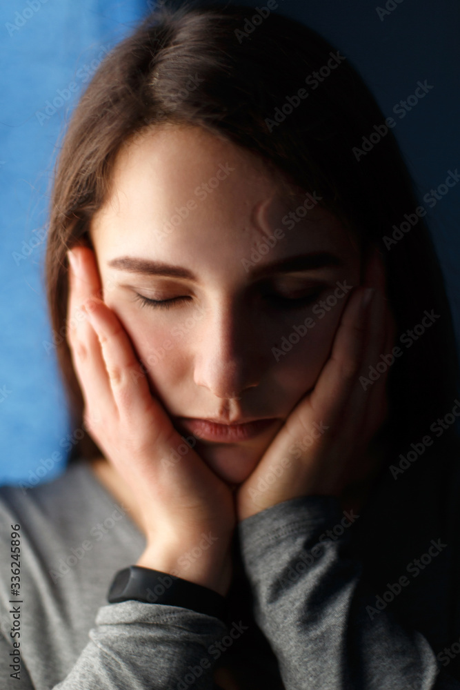 Portrait of a beautiful girl with closed eyes in the blue room Portrait of a beautiful girl with closed eyes in the blue room