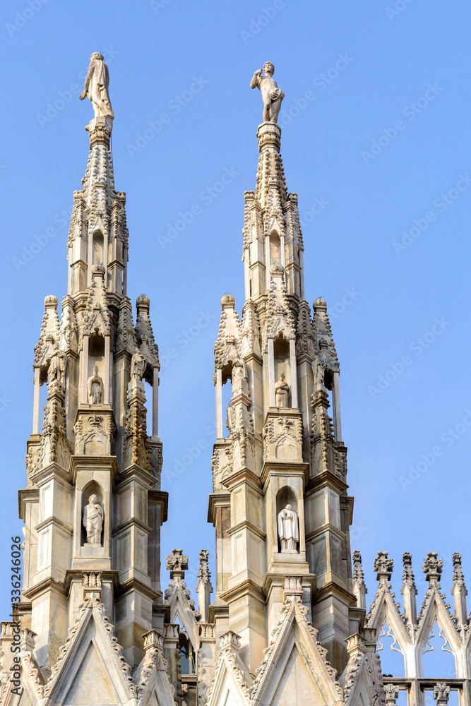 Cathedral of the Nativity of the Virgin Mary in Milan. Cathedral of white marble. The Late Gothic building contains many spiers and sculptures, marble peaked towers and columns.