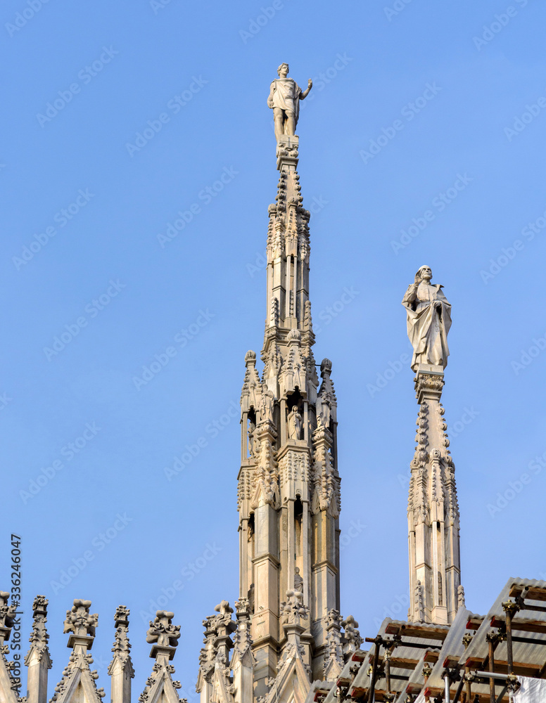 Cathedral of the Nativity of the Virgin Mary in Milan. Cathedral of white marble. The Late Gothic building contains many spiers and sculptures, marble peaked towers and columns. Cathedral of the Nativity of the Virgin Mary in Milan. Cathedral of white marble. The Late Gothic building contains many spiers and sculptures, marble peaked towers and columns.