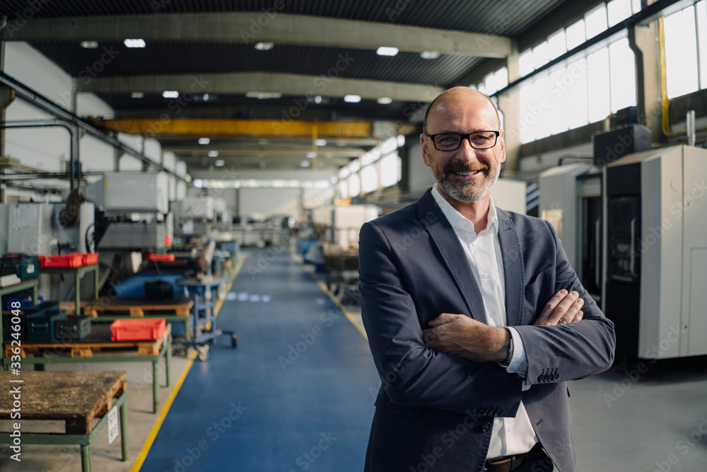 Portrait of a smiling businessman in a factory Portrait of a smiling businessman in a factory