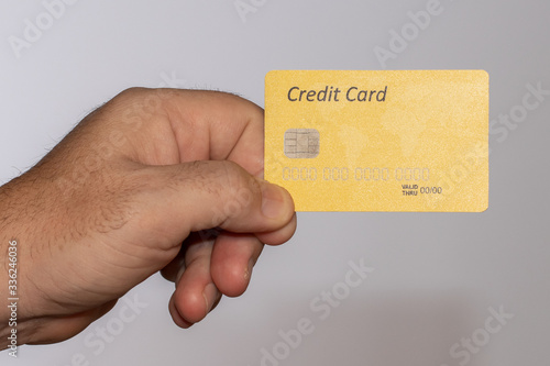 male hand with credit card on white background