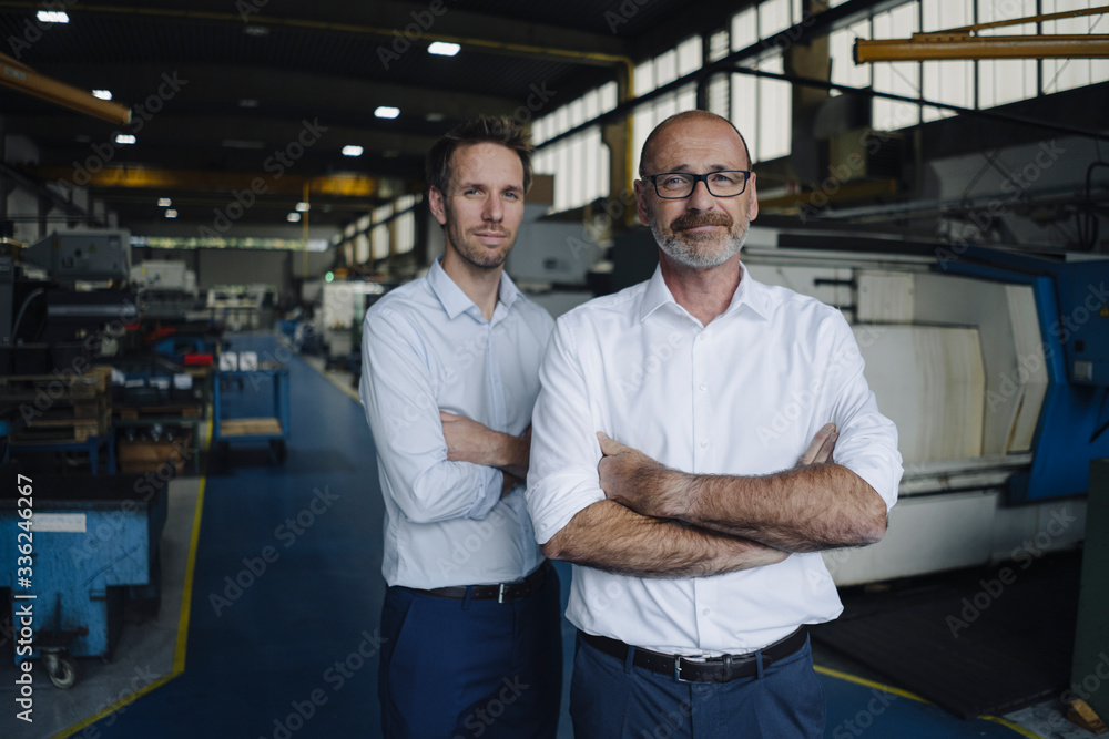 Portrait of two confident men in a factory Portrait of two confident men in a factory