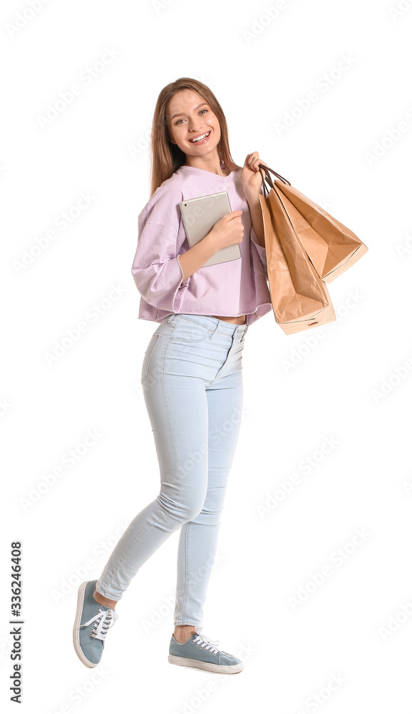 Young woman with tablet computer and shopping bags on white background Young woman with tablet computer and shopping bags on white background