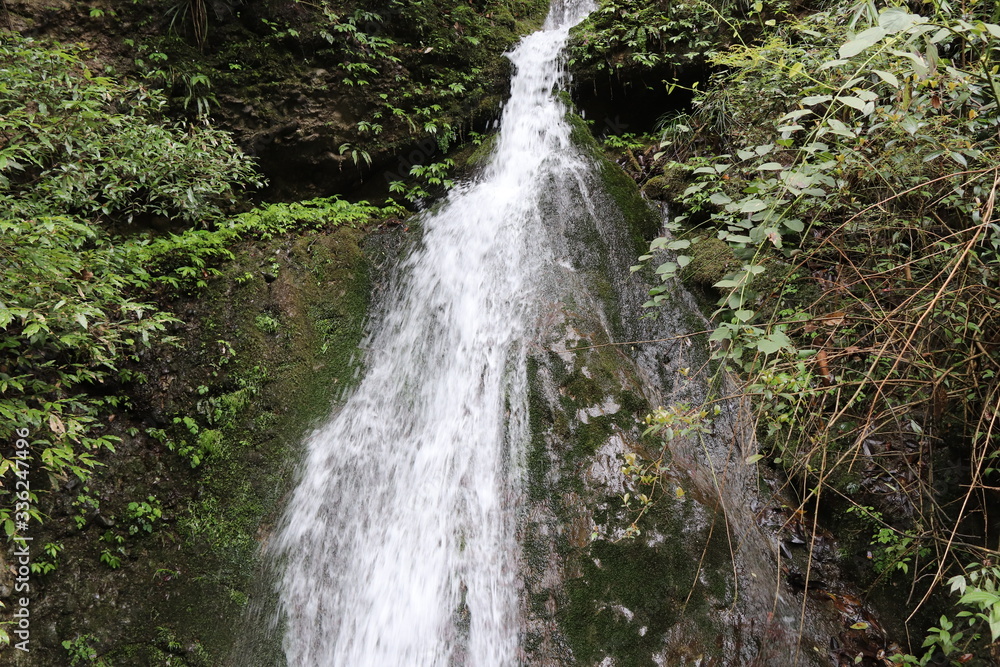 Beautiful landscape of a waterfall in a forest in a Mountain in Sichuan, China Beautiful landscape of a waterfall in a forest in a Mountain in Sichuan, China