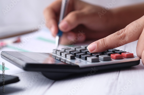 Woman accountant use calculator on table at office