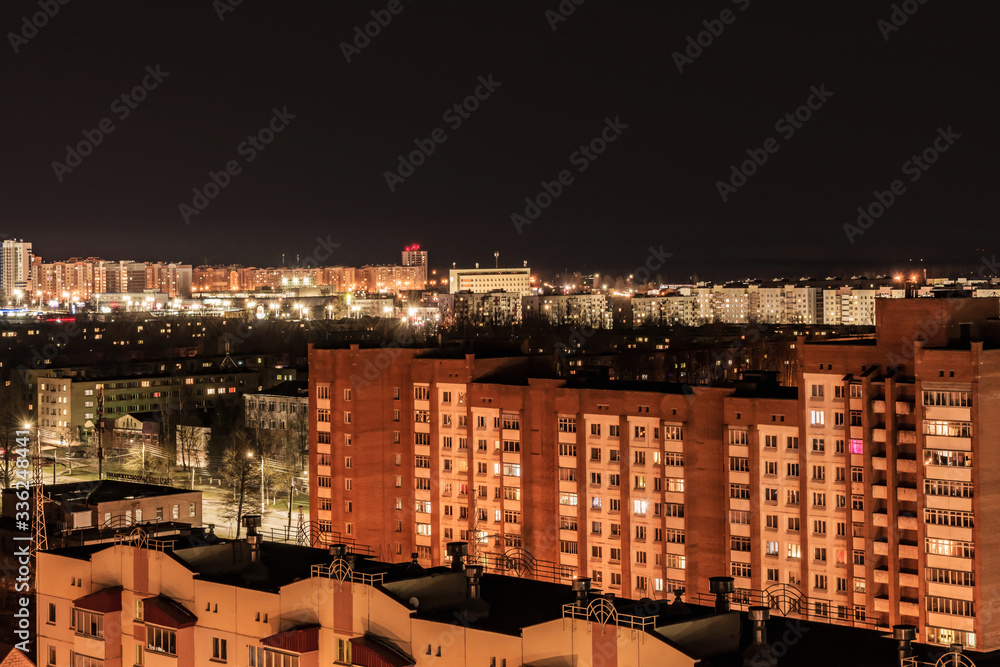 night view of nine-story houses and streets with lanterns, Belarus Vitebsk, architecture abstract background