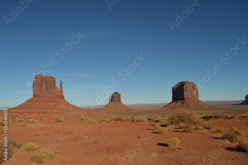 Iconic West and East Mitten Buttes at Monument Valley in Utah in early afternoon.