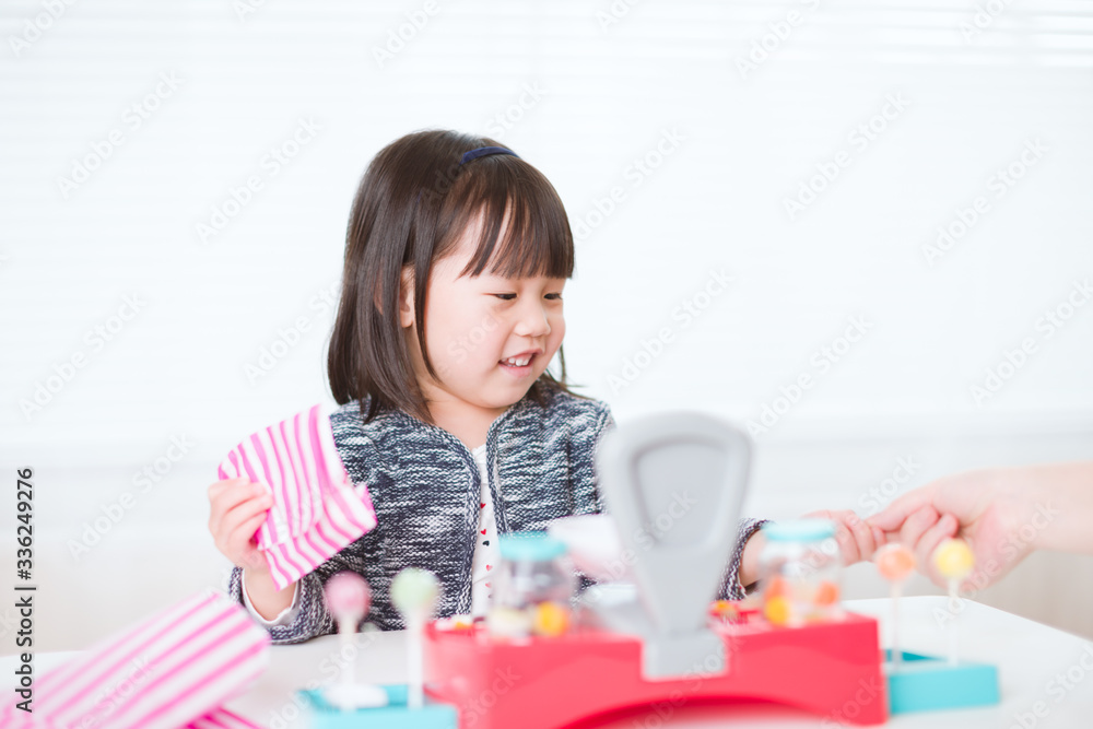 toddler girl pretend play sweet shop keeper at home