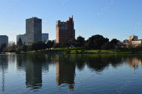 Buildings cast reflections on Lake Merritt in downtown Oakland, California. 
