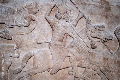 фотографія Ancient persian bas-relief depicting warriors on horseback
