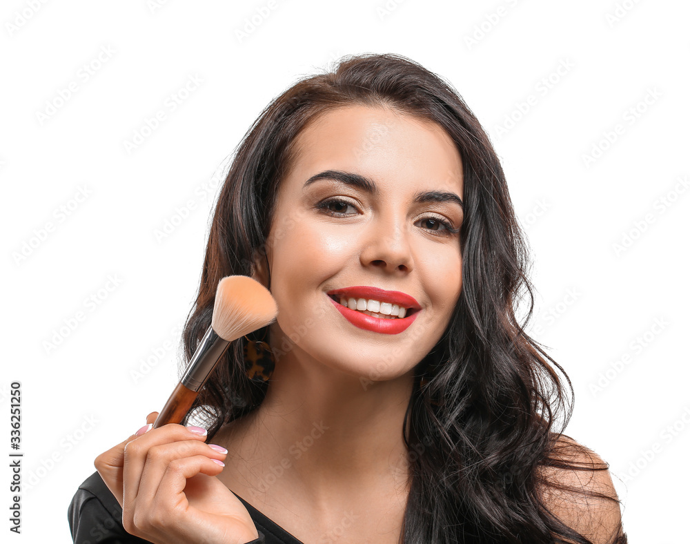 Beautiful young woman with makeup brush on white background Beautiful young woman with makeup brush on white background
