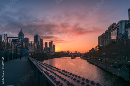 Melbourne cityscape at sunrise with Melbourne CBD skyscrapers and Southbank © Olga K